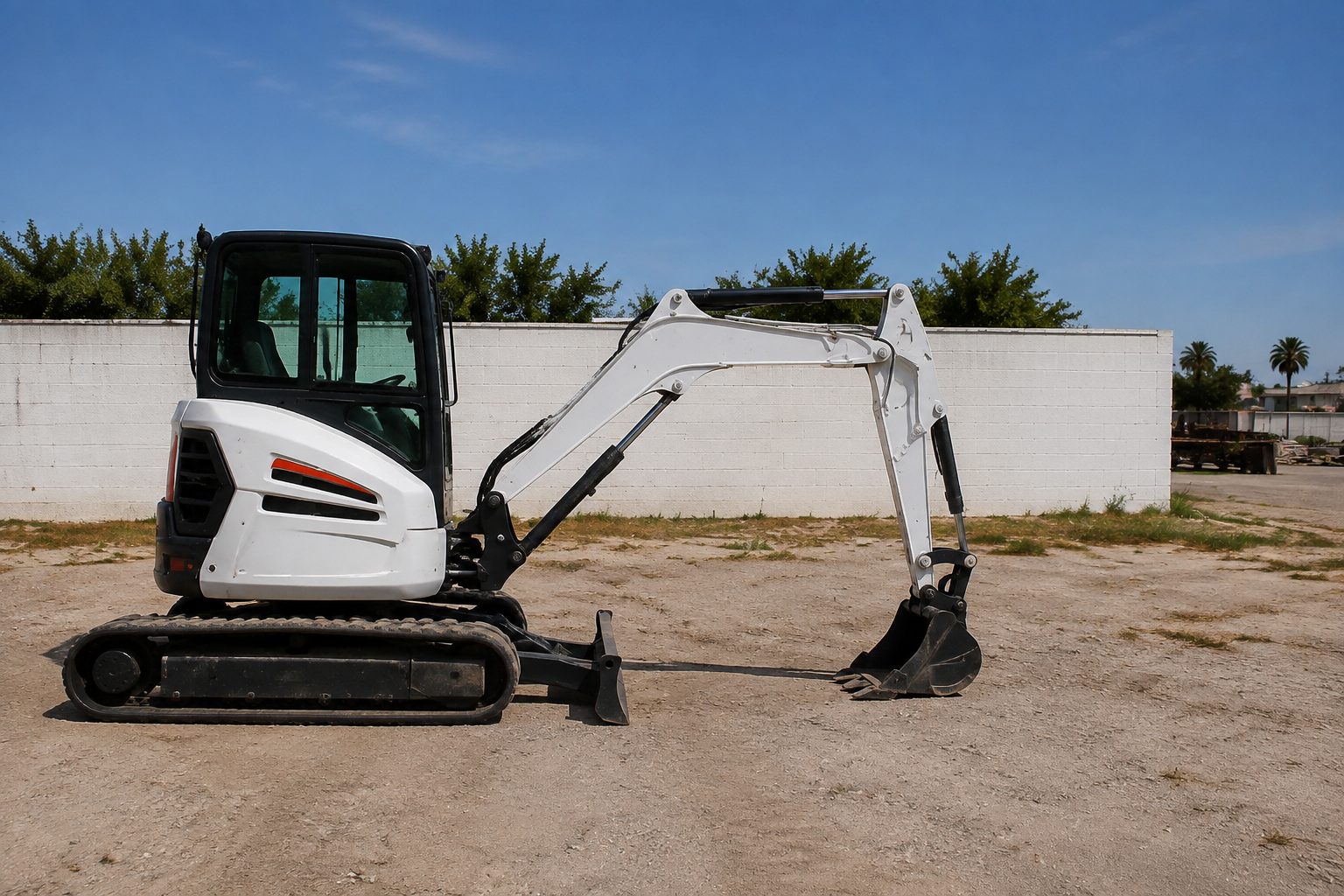 White Bobcat mini excavator at the BNRB rental yard.